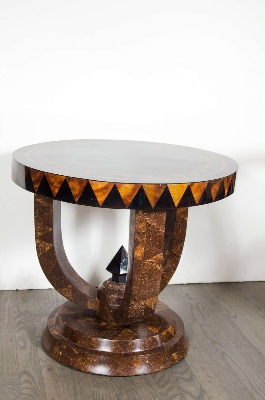 This gorgeous Mid Century Modernist gueridon table features an elaborate horn geometric inlay design. The stepped pedestal base feature three banned legs topped with a spoke detail.

