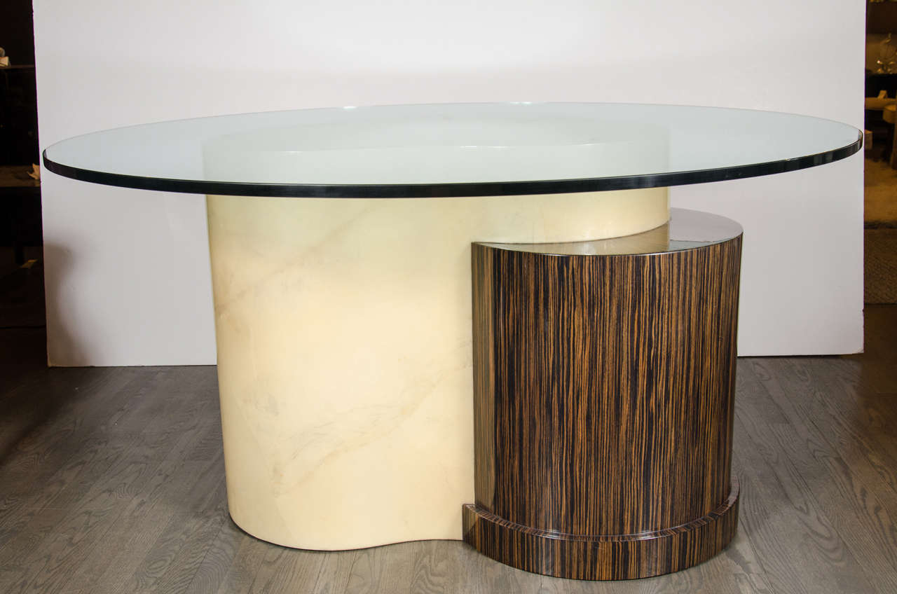 This handsome Mid-Century Modernist table combines two interlapping organic forms. One is a demilune shape composed of Macassar with its Classic high keyed contrasting woodgrain reminiscent of tiger's eye gemstones. The other is a cloud-shaped form