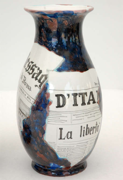 An unusual vase glazed in blues and reds to look as though it was decoupaged with torn pieces of Italian newsprint. Signed 