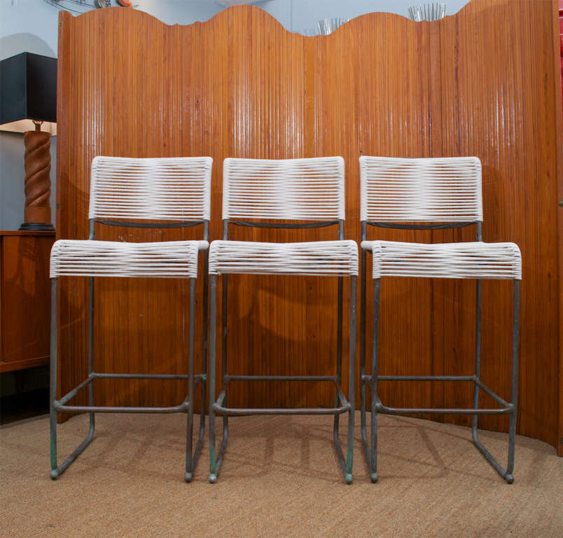 Set of three matching bronze finish bar stools designed by Walter Lamb with new sail cord.