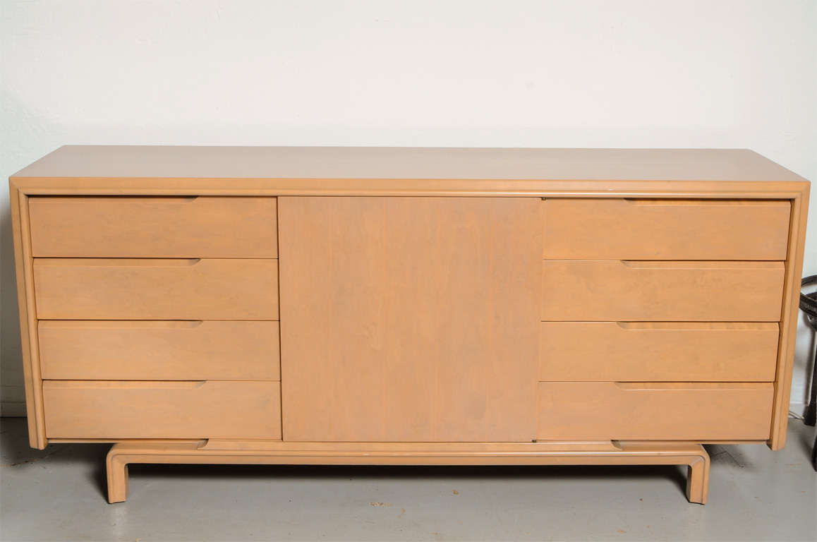 This clean-lined, no-nonsense, credenza by Edmond Spence charms us with its quirky between-eras styling. A warm grey-washed finish over subtly grained maple. Marked 