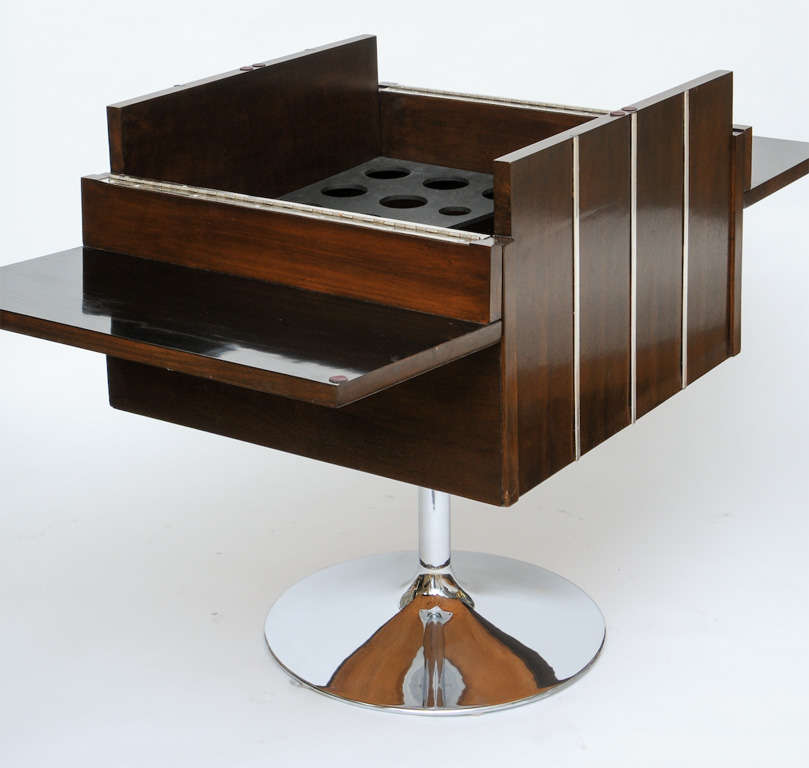 Bachelor-pad-ready 60's walnut and chrome bar. Top folds down to form two formica- topped shelves, while a drop-in divider keeps your Stoli from bumping into your Bombay.