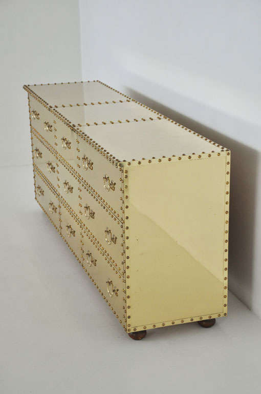 Glamorous nine-drawer dresser by Sarreid. Sideboard is clad in brass with nailhead trim.

 