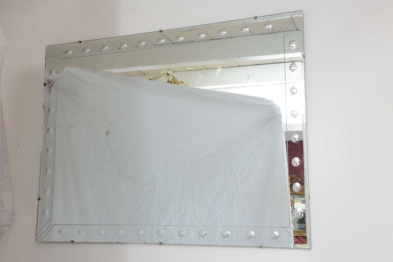 Simple and chic 1940's Art Deco mirror with bullseye edging.