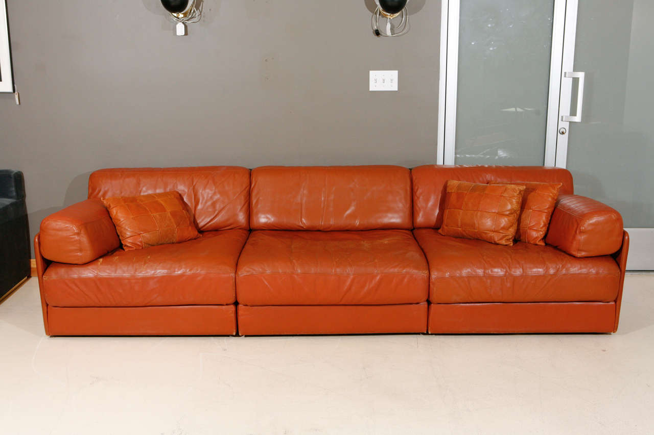 Modular Leather Sleeper Sofa by De Sede. Three piece sofa composed of a central section and two corner elements. Can be configured as a long sofa or as a love seat and chair.