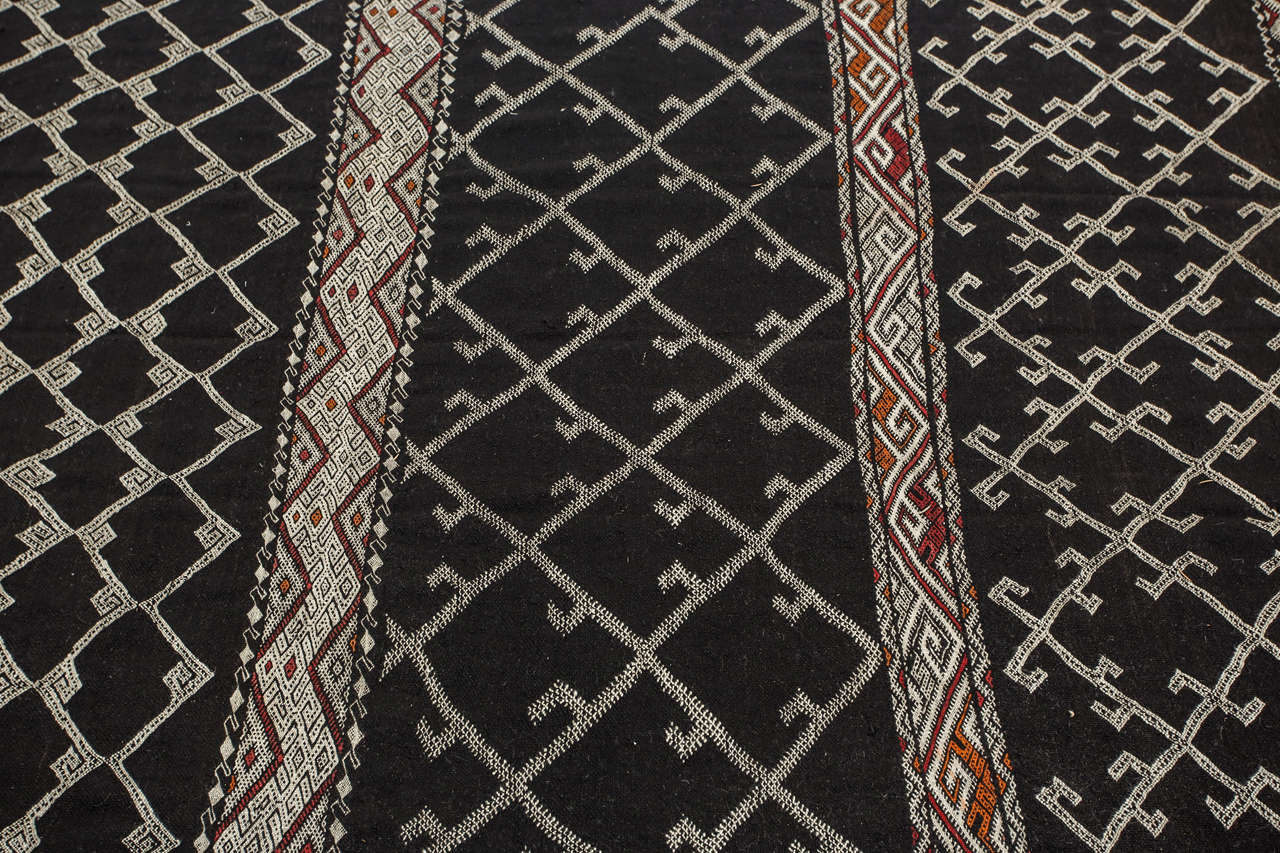 Vintage North African Nomadic Rug, black Camel hair color with wool and cotton embroidered geometrical Modernist designs.
This Moroccan rug was used for room separation in the Berber tents, those rugs are light for easy folding and travel for the