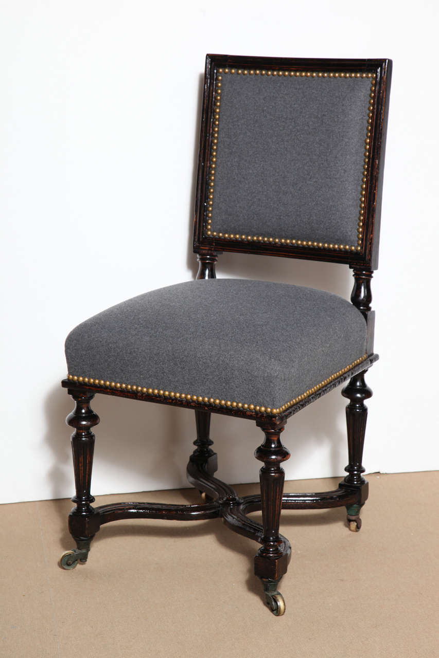 Seat of 14, 19th century French ebonized and upholstered dining chairs.