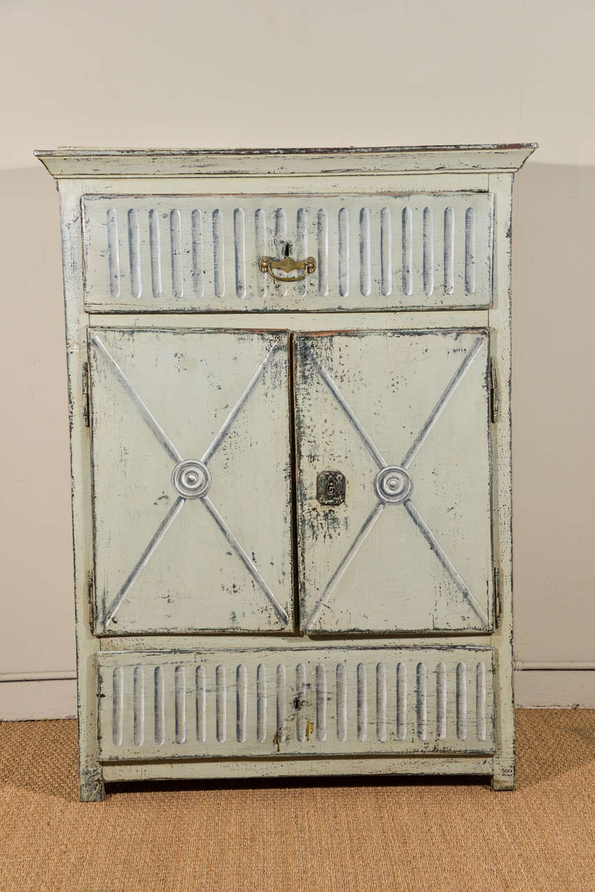 Two-door, two-drawer Swedish cabinet, circa 1830, with trompe l’oeil painted finish and later brass pull.