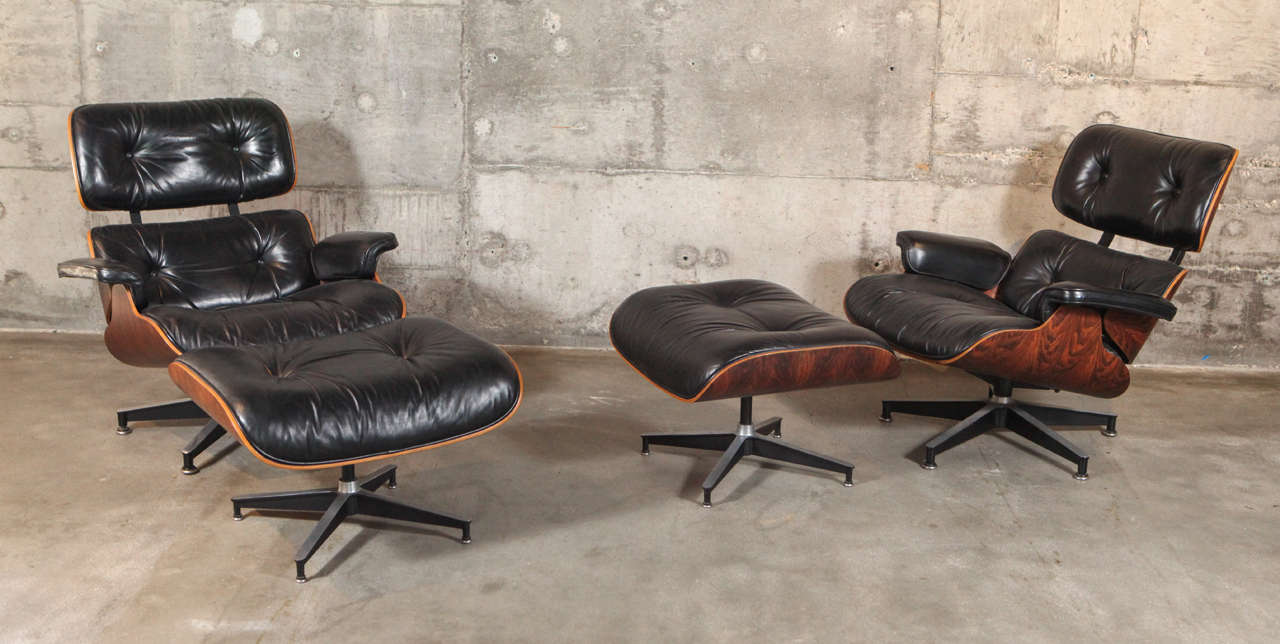 Pair of matching Eames lounge chairs and ottomans (670/671) by Herman Miller; stamped 1975 and 1976.