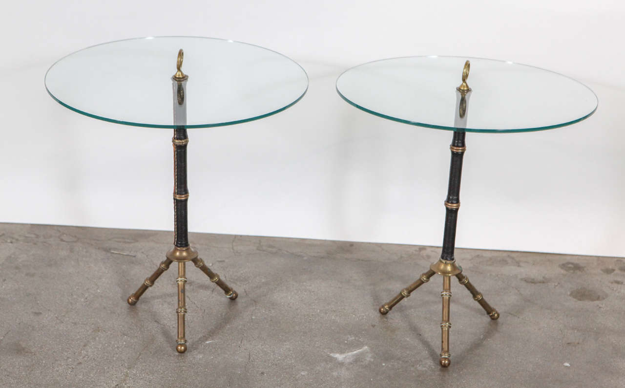 French leather wrapped brass circular glass top table with tripod base and decorative loop handle by Jacques Adnet.