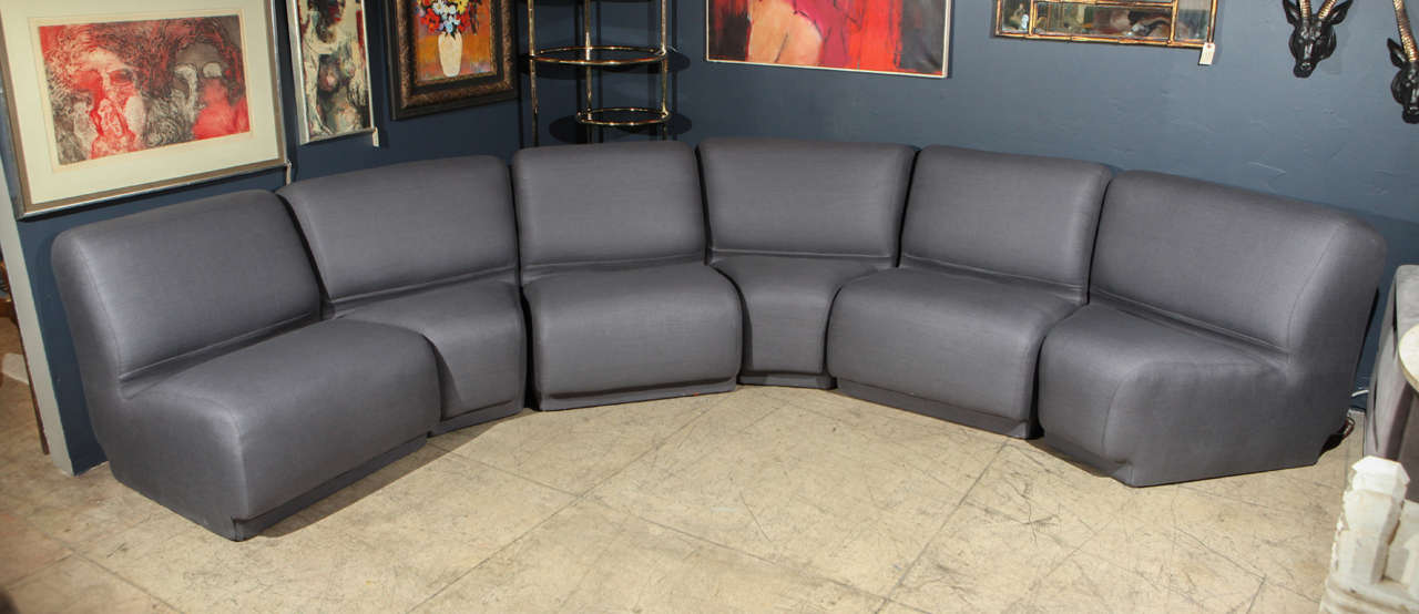 A spectacular modular sofa by Knoll. Semi-circular sofa consists of six separate sections, three regular rectangular sections and three pie shaped sections. Newly reupholstered in charcoal gray linen. 

Each rectangular sectional measures 26.5