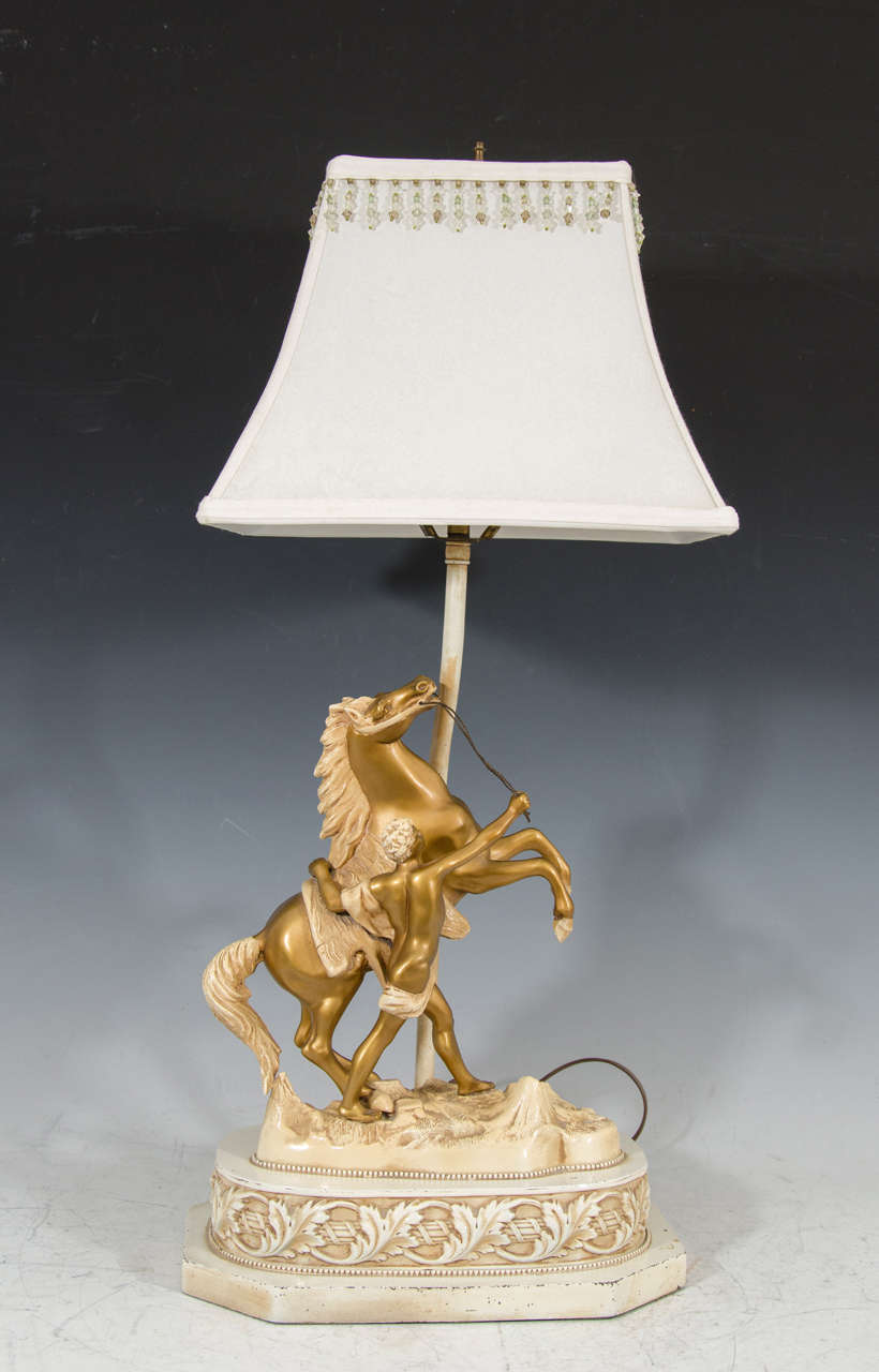 A vintage 1940s figural horse and rider table lamp with beaded rectangular shade. Original wiring. Good vintage condition with age appropriate wear. Some scratches.

7690.