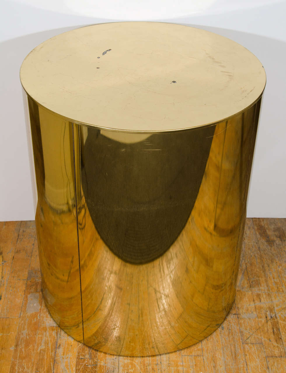 A vintage cylindrical brass drum table signed C. Jeré. Can be used as a dining table (it supports a glass top) or as a pedestal.

Fair condition with scratches, wear, and dings.