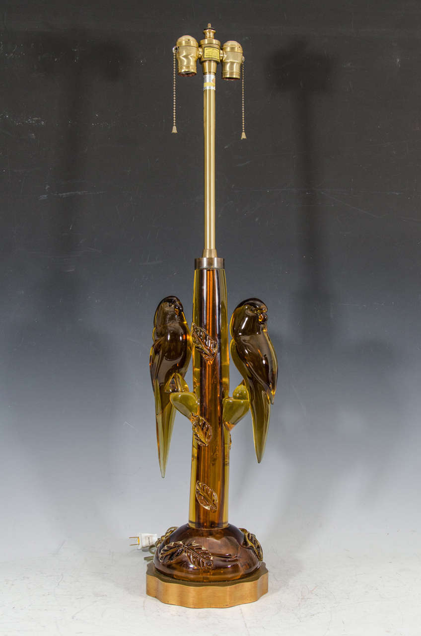 Absolutely Rare and Incredible pair of Amber Hand Blown Murano glass parrot table lamps on a giltwood base by Alfredo Barbini.They are a wonderful Pair of Lovebirds poised on Branches with beautiful leaf designs scattered on the base and