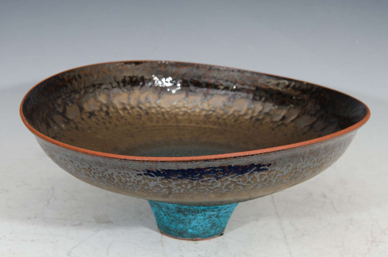 A spectacular Jeremy Briddell large tri-color pottery bowl with copper glaze.

Jeremy Briddell grew up in St. Louis Missouri but has lived in Pennsylvania, Kansas City, Omaha Nebraska and for the last 17 years Arizona. He did his undergraduate