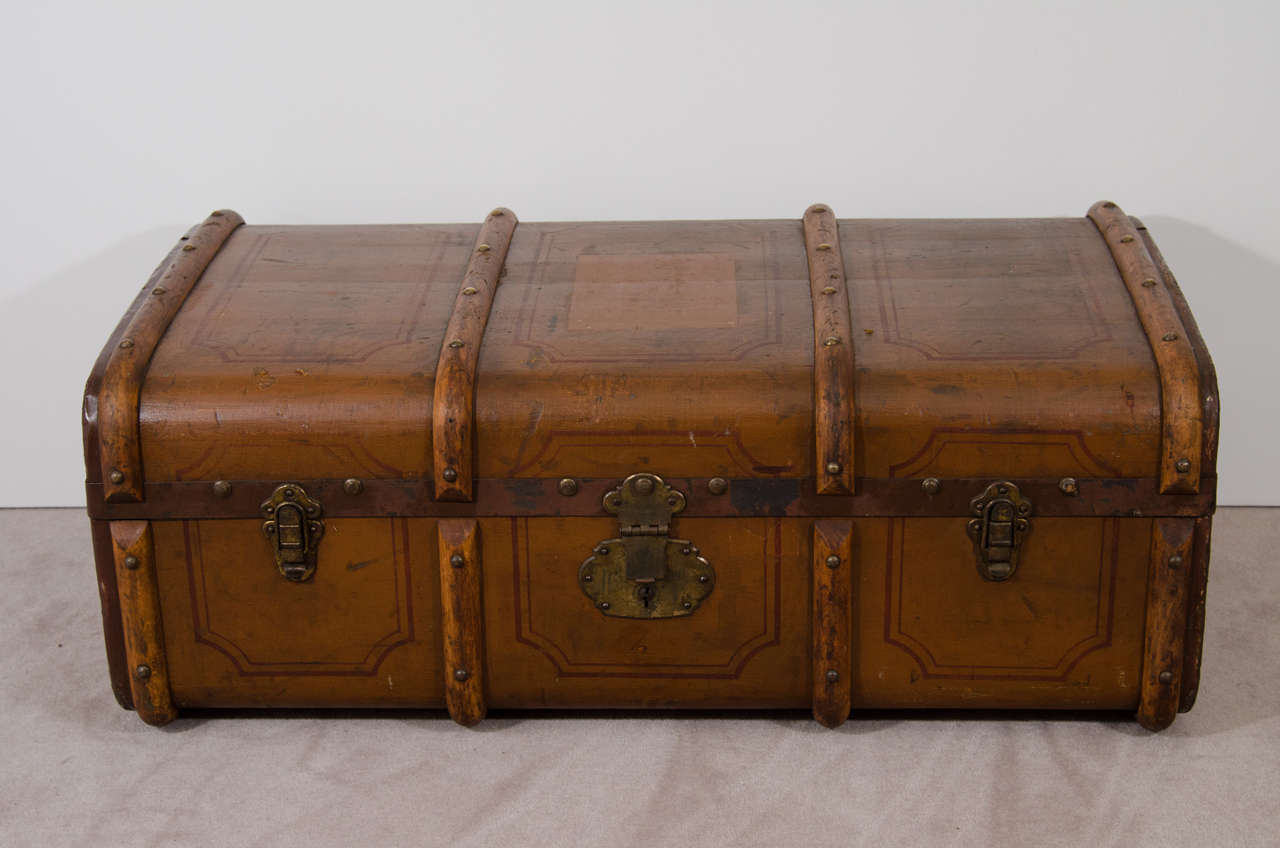 An antique English hand-painted wooden trunk with leather handles, metal hardware and nail head detailing. There is an interior removable compartment.

Good condition with age appropriate wear and patina. Some nicks and scratches. The trunk