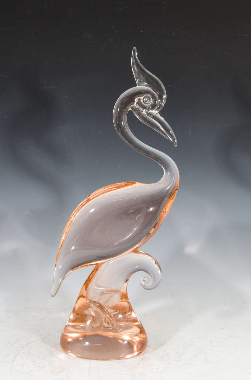 A vintage pair of solid clear and peach colored Murano glass sculptural exotic birds.