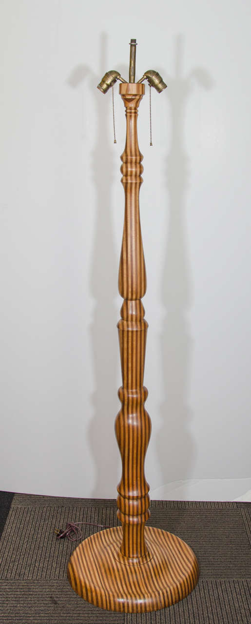 A vintage large turned wood stacked floor lamp. The lamp has a center stem and two adjustable sockets for Edison base bulbs.

Reduced from: $2,200