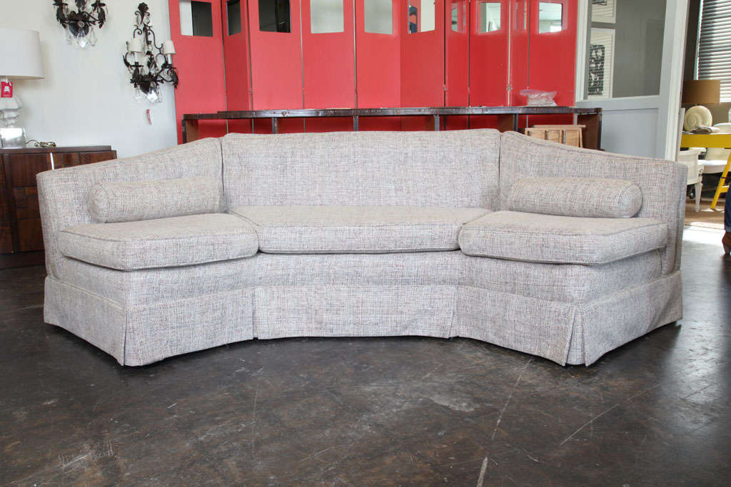 Mid-century octagonal sofa upholstered in beige tweed.