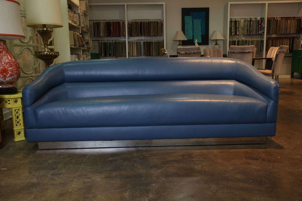 Blue leather sofa with brass plinth base attributed to Milo Baughman.