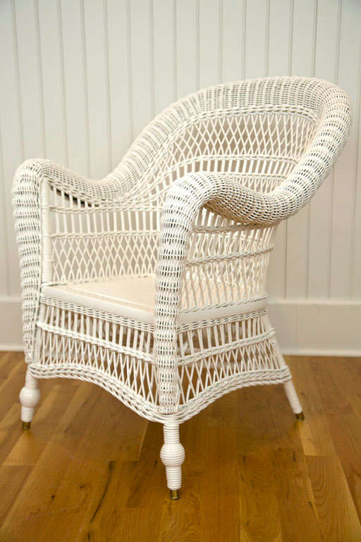 Victorian Wicker Arm Chair with rolled back tapered at the toe and caned seat. Two available.