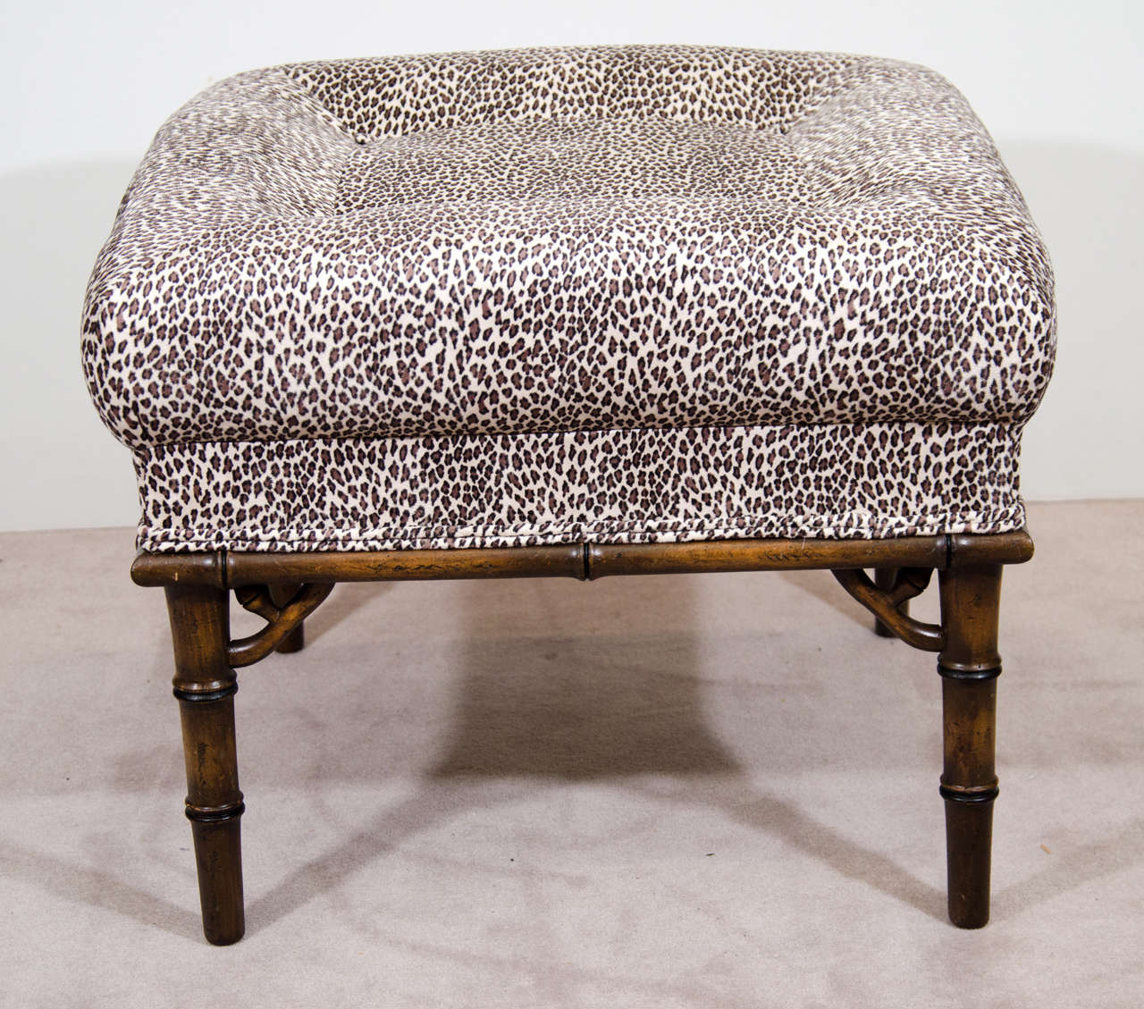 A pair of vintage ottomans or benches with faux bamboo legs and cushions that have been recently reupholstered in ocelot or leopard print ultra-suede.

Reduced from $2,250