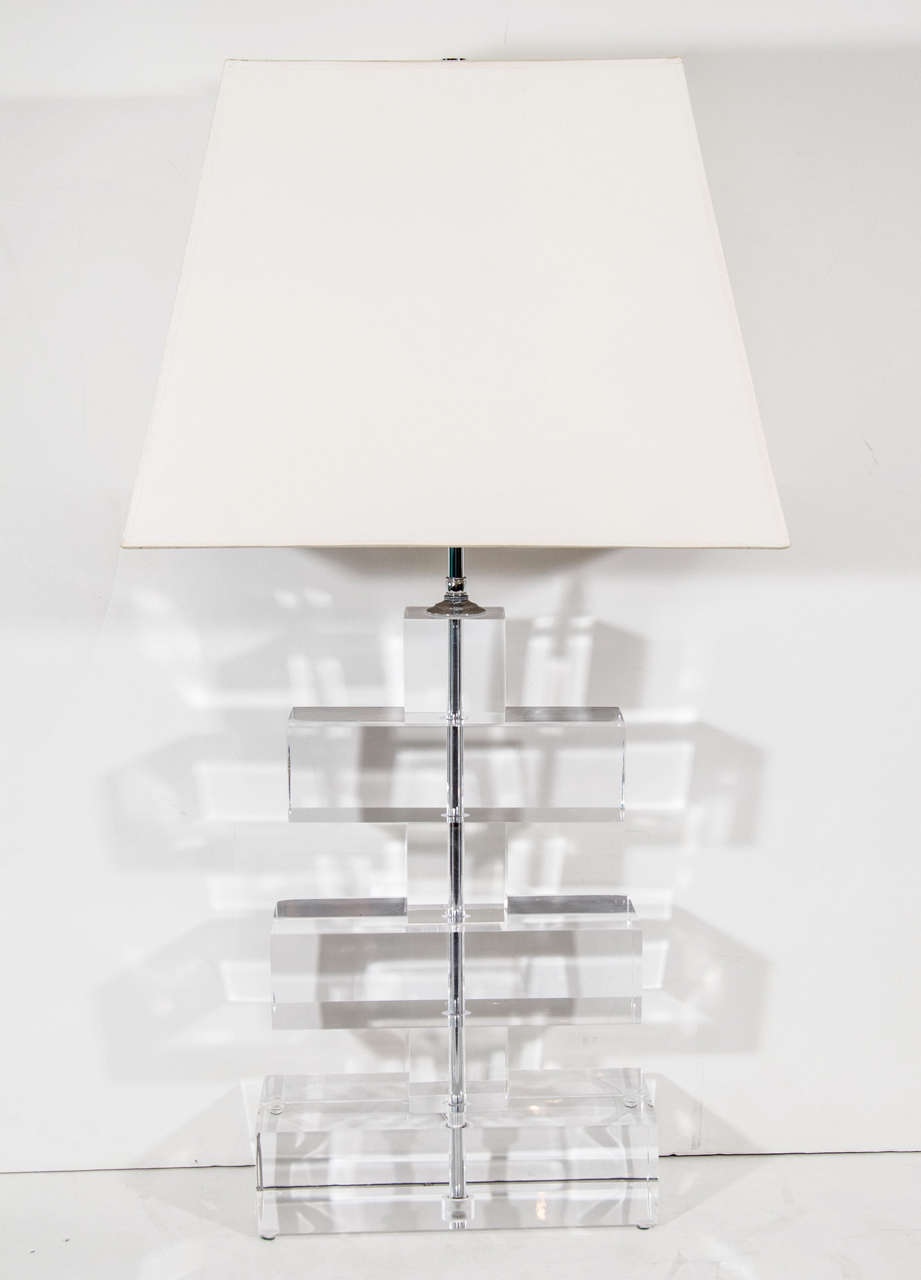 A vintage table lamp with thick-cut, stacked clear lucite blocks. The piece is in the manner of noted designer Karl Springer

Reduced from: $1875