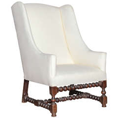 An Antique Walnut Louis XIV Style Wing Chair