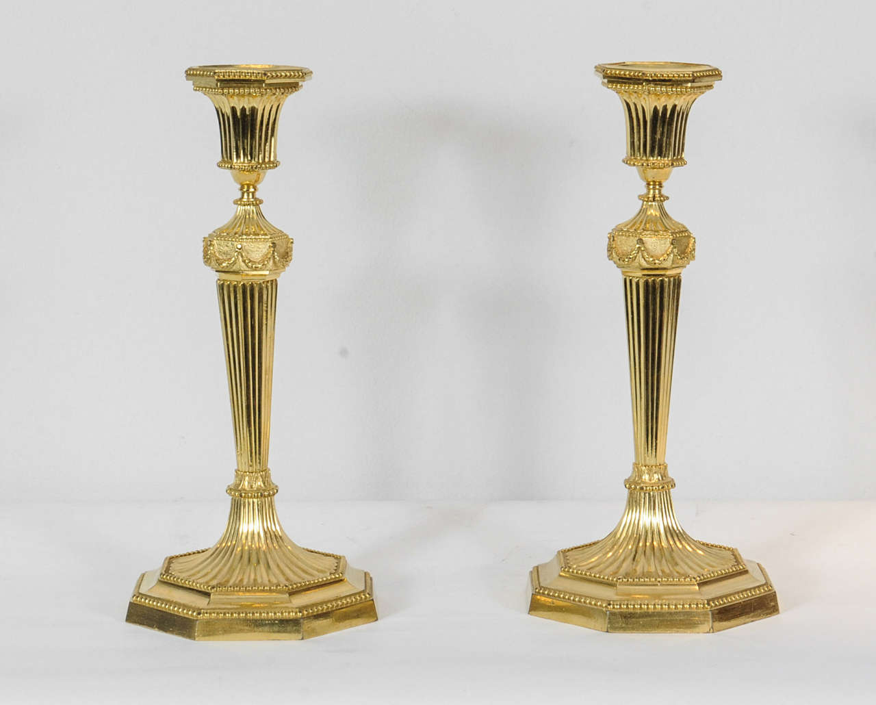 A pair of English Regency gilt bronze candlesticks, circa 1800