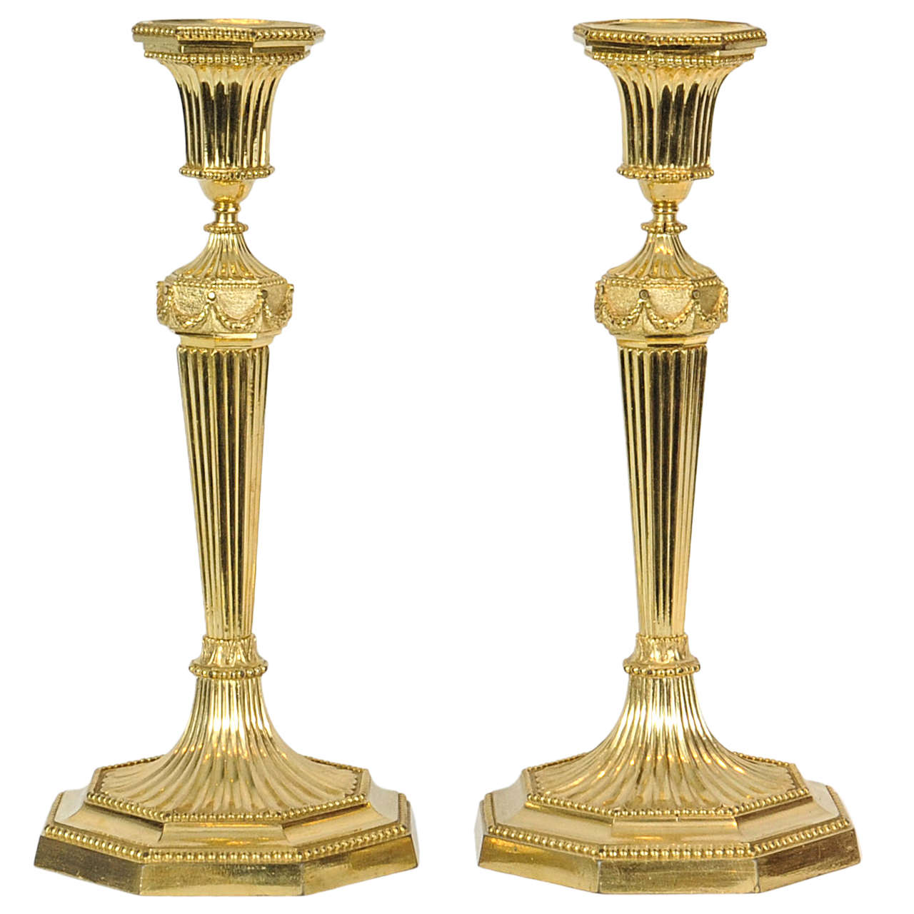 A pair of English Regency gilt bronze candlesticks, circa 1800 For Sale