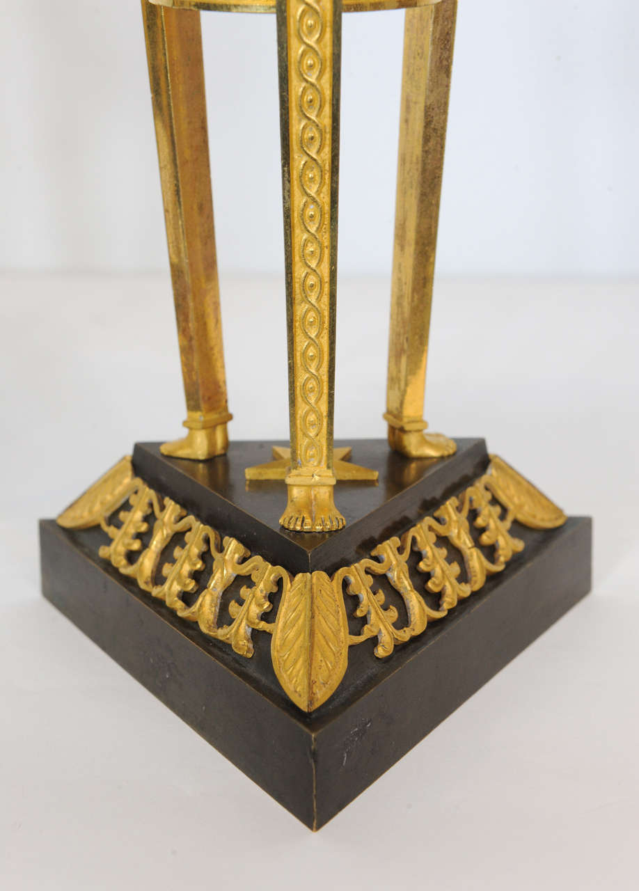 Ormolu A pair of Empire ormolu and patinated bronze candlesticks, circa 1800