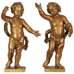 A pair of Dutch giltwood figures of putti, circa 1660