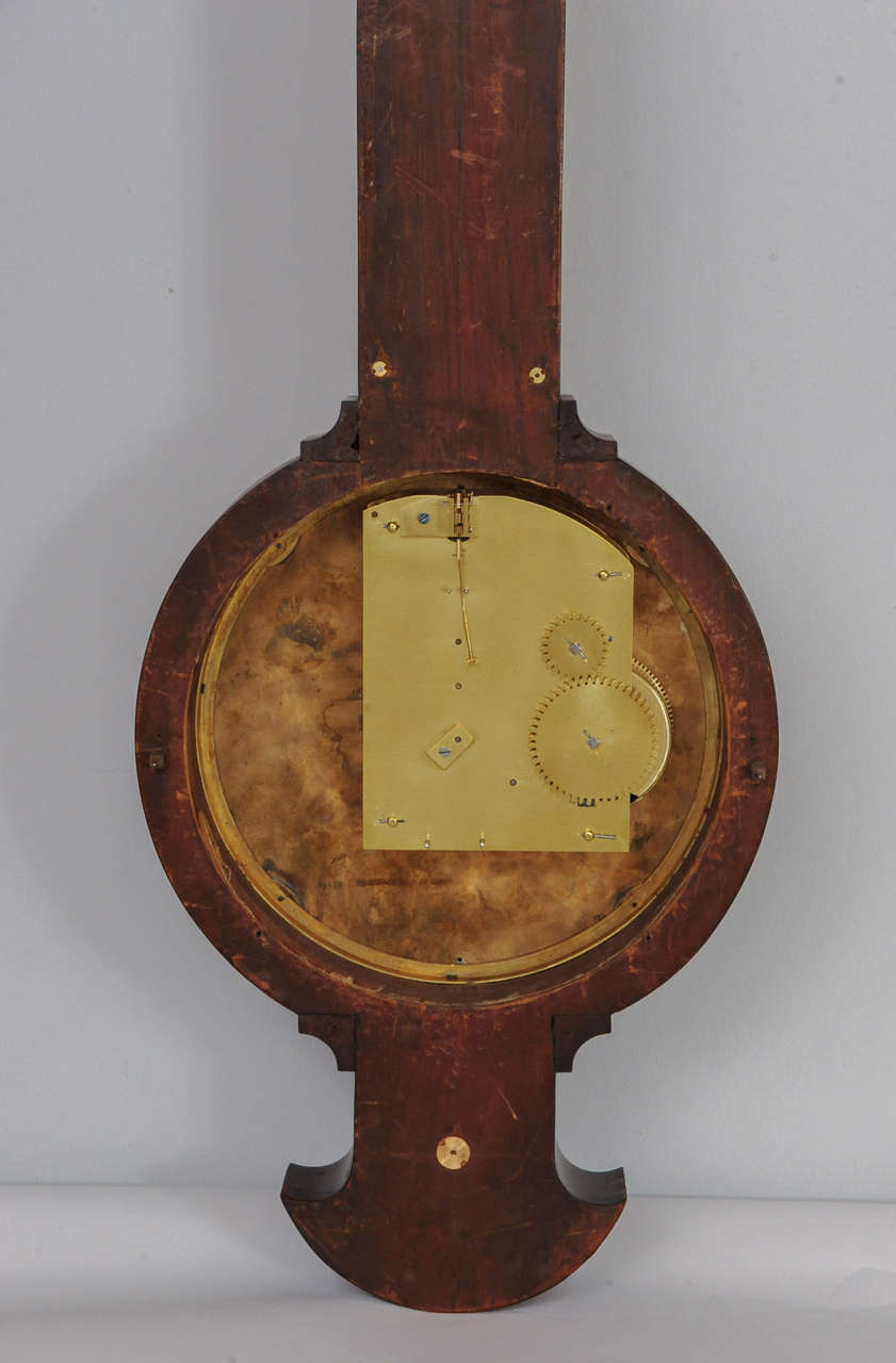 Mahogany A near pair of pendant Empire mahogany wall clock and barometer, circa 1820 For Sale