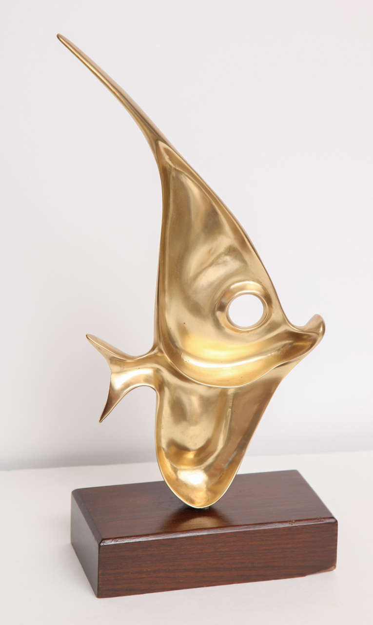 Beautiful brass fish sculpture on a wood base, circa 1960.