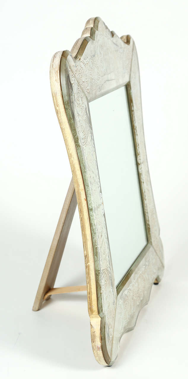 A pretty verre Églomisé vanity mirror nicely framed with decorated antique mirror. The mirror is wood backed with a sturdy wooden easel to support it. This mirror makes the perfect addition to your vanity table.