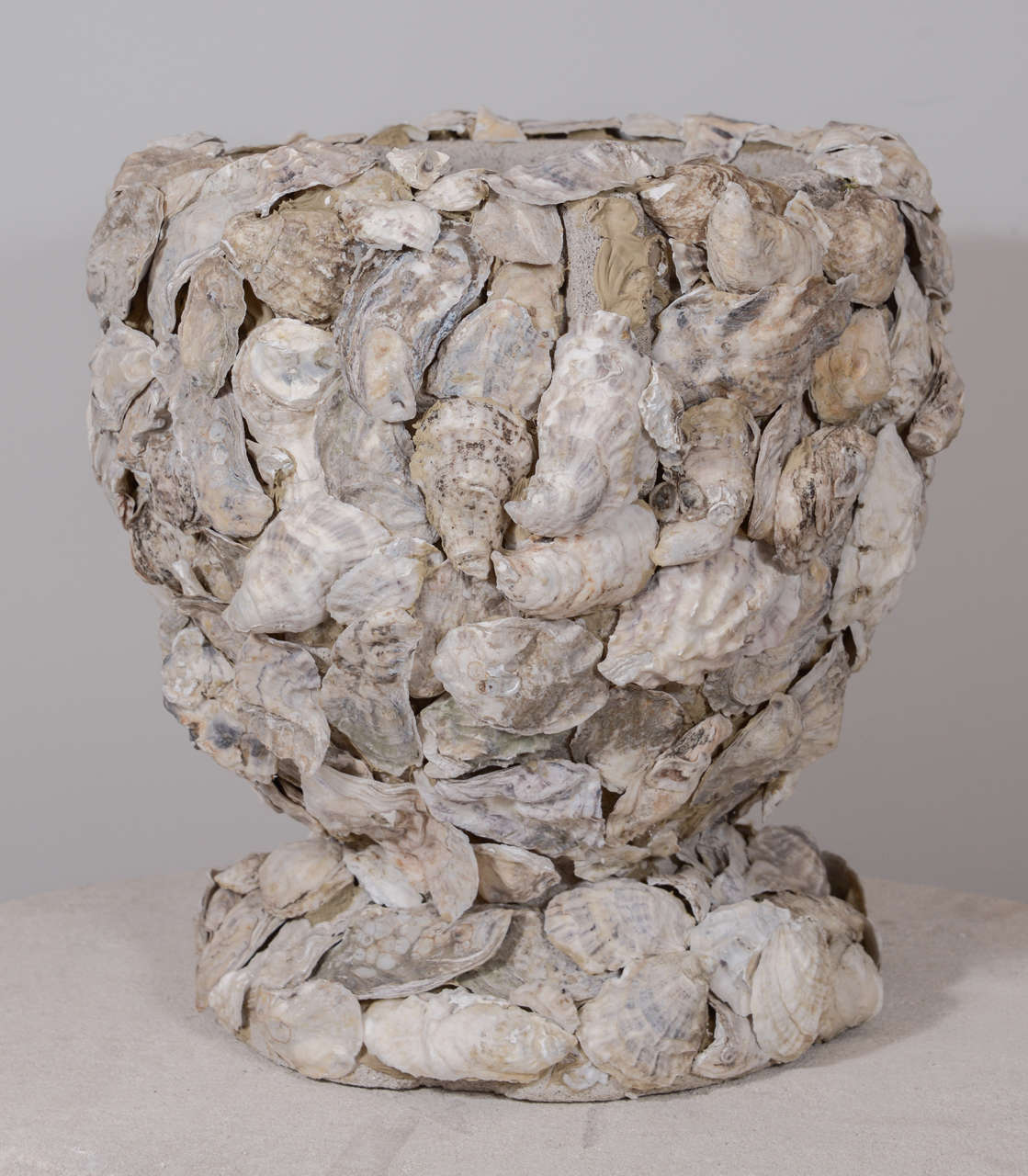 Pair of vintage concrete cache-pots covered in oyster shells.