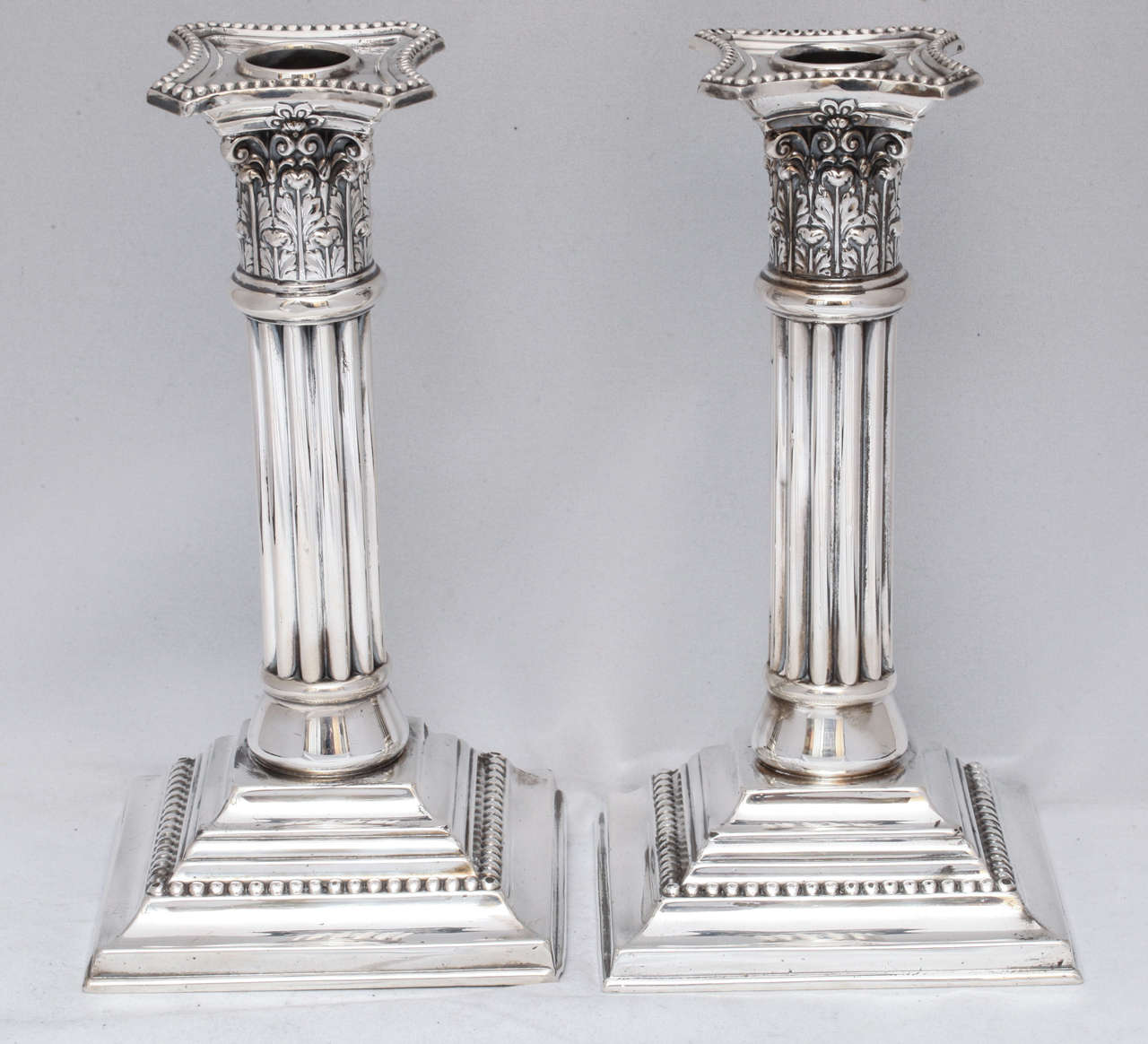 Edwardian pair of sterling silver, Corinthian column candlesticks, The Mauser Manufacturing Corp., New York, circa 1905. Measures: 8 1/4