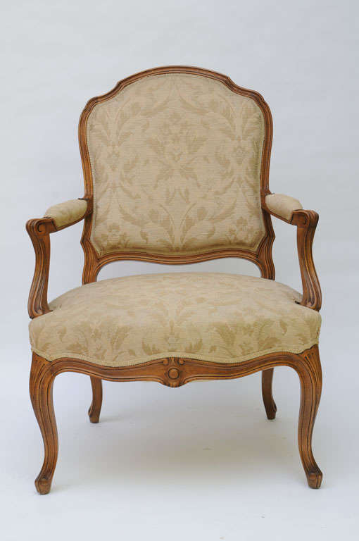 ..SOLD..Lovely pair of Louis XV style fauteuils beautifully carved and upholstered in a damask style weave, in a ala reine back. Made in Athens by Saridis, the famed furniture makers for which TH Robsjohn-Gibbings designed his antiquities inspired