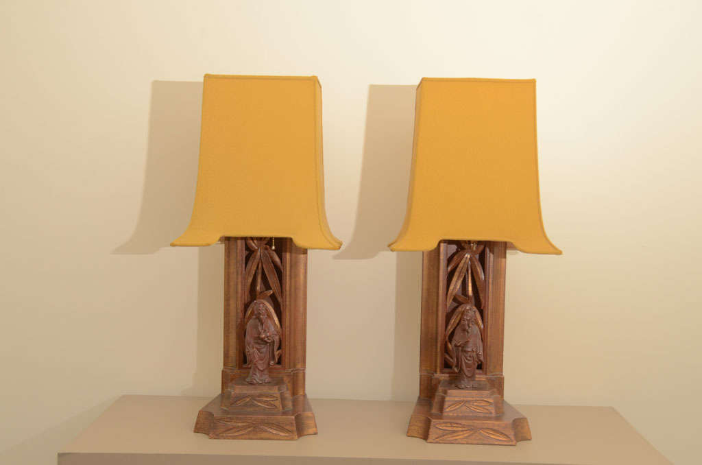Pair of figurine lamps by James Mont. the lamps have one of mont's signature carved bamboo which acts as a back drop for this pair of Asian figurines  which both retain there original leafing. The lamps also retain there original shades which have