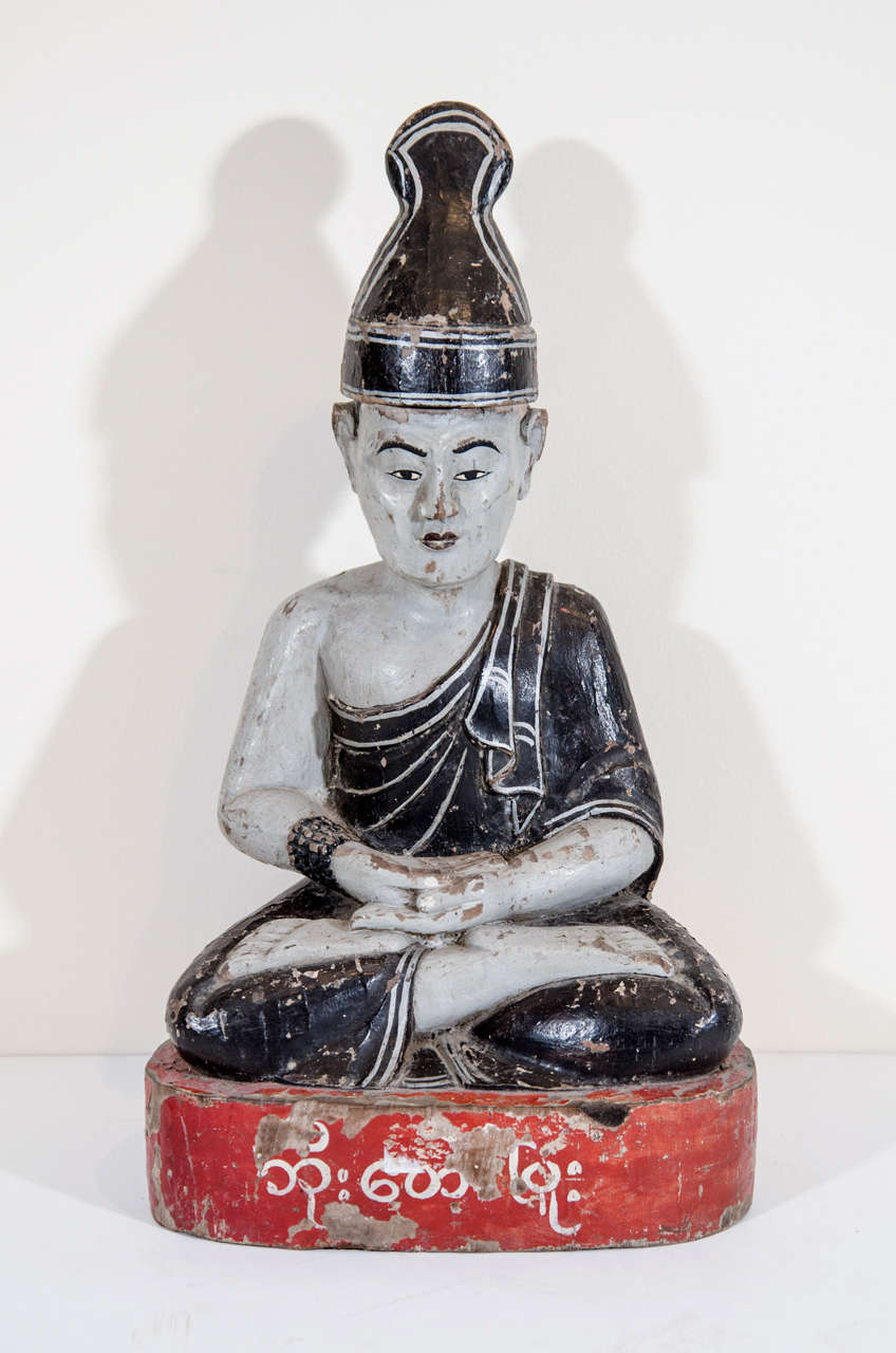 A colorful Burmese seated temple monk. The Burmese characters on the base state the name of the person who donated the carving to the temple. 
BH435
