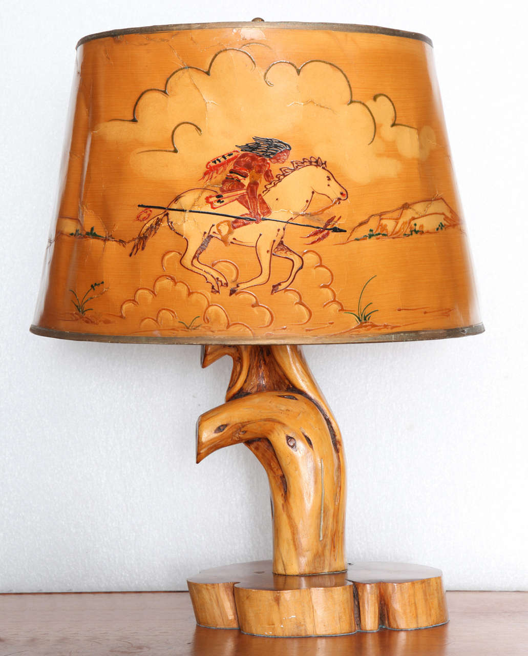 Influenced by the work of Thomas Molesworth’s Shoshone furniture company, the burl root lamp base with goatskin lampshade has exquisite hand-painted scene of Indian brave on horseback hunting buffalo with spear.

Comes from Wyoming. 