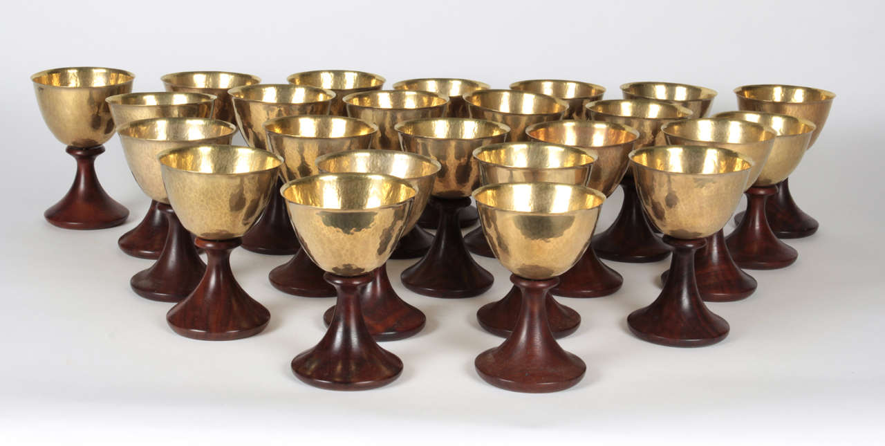 LAWRENCE HUNTER, San Diego, California

Punch Bowl set c.1965

Hand hammered and hand wrought large asymmetric punch bowl with matching ladle, turned walnut pedestal platter and twenty four hand wrought brass and walnut pedestal shape goblets