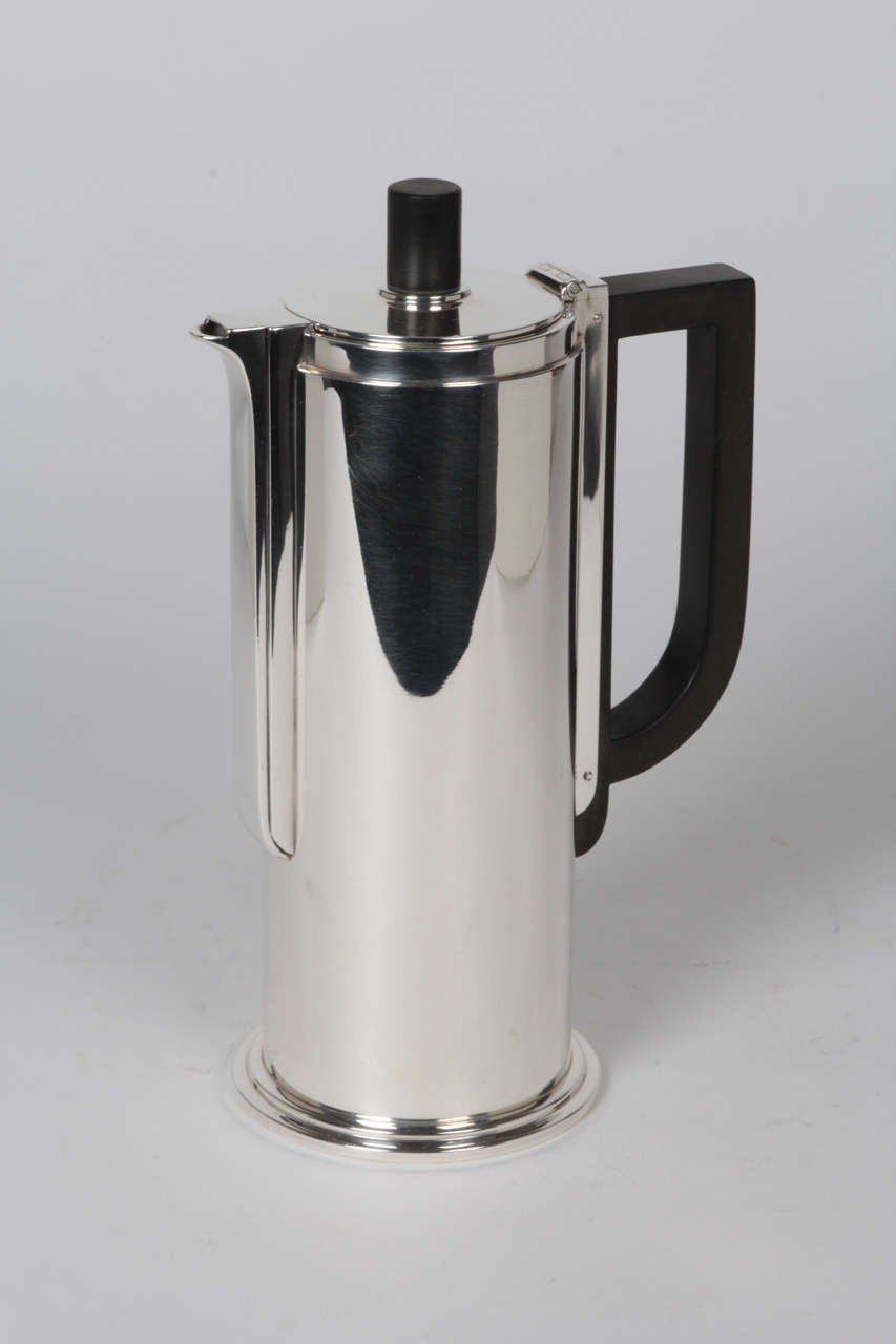 ALBERT BARNEY (? -1955) American
JOHN C. MOORE  (1907-1947)  New York
TIFFANY & COMPANY  (1868-)  New York  

“Century Modern” chocolate or demitasse pot   1936

Handwrought sterling silver, fiber handle and finial

Stamped: TIFFANY & Co.