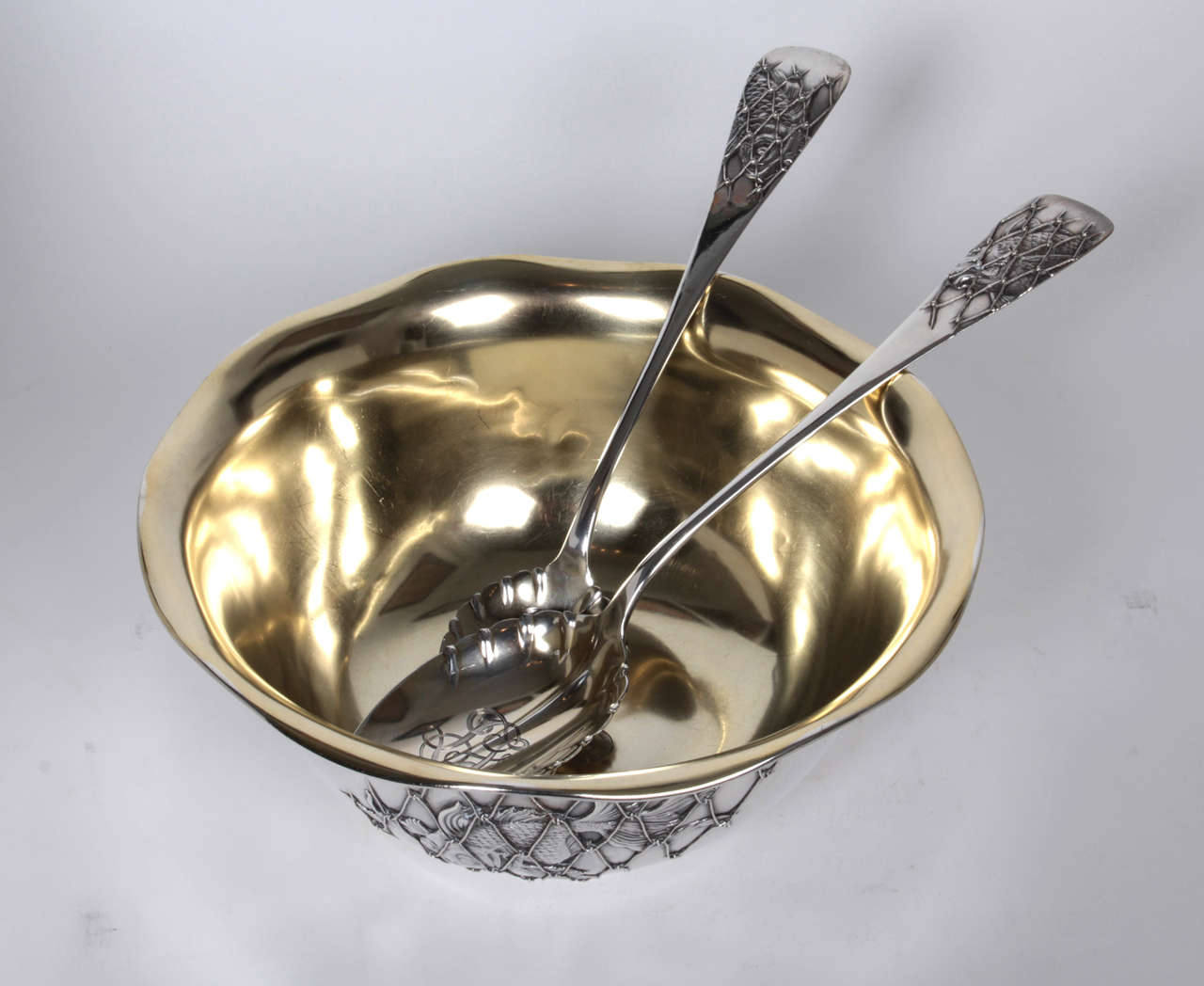 WHITING MANUFACTURING CO.  North Attleboro, MA

“Koi” serving bowl with matching servers   c. 1880

Sterling silver serving bowl and matching servers with applications of Koi fish behind nets, gilt interior

Marks: on base: lion with W in oval
