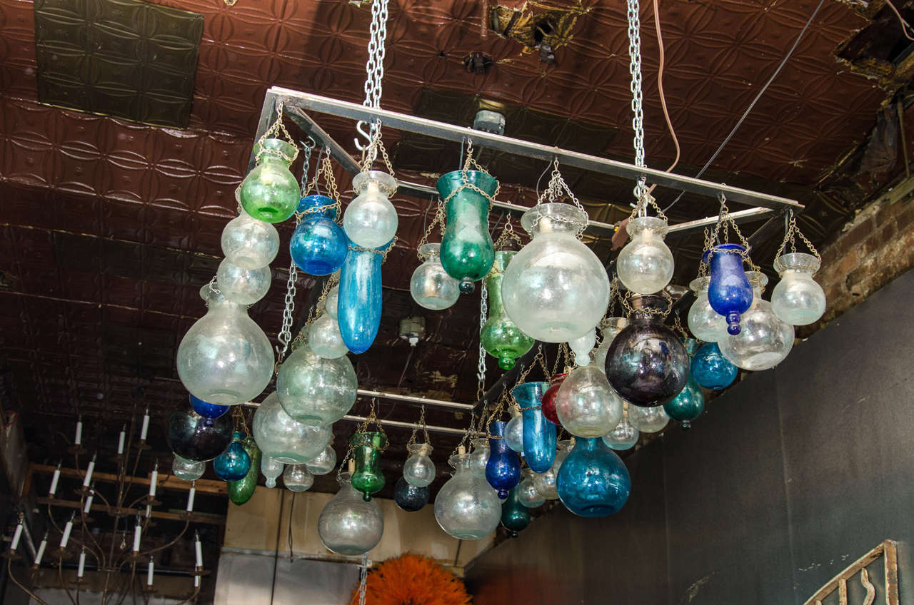 Cafe style rectangle steel chandelier with Egyptian handblown glass in assorted colors and sizes. Available with antiqued bronze frame.