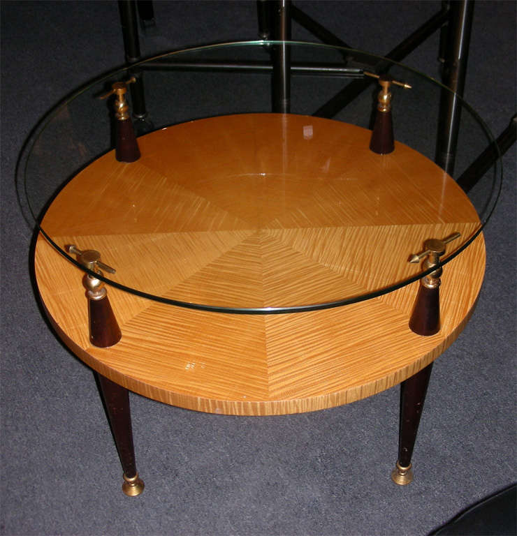 Small 1950s guéridon with base in mahogany and gilt bronze elements; top surface in sycamore; the highest one in glass.
