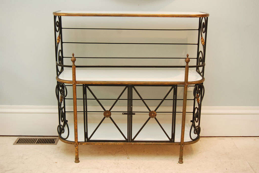 French wrought metal and brass bakers rack with three milk glass shelves.