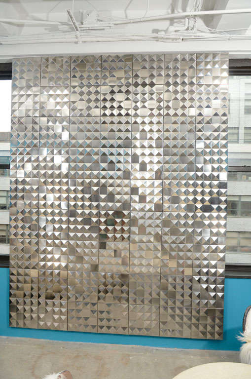 A very cool modern wall hanging comprised of squares that create a random pattern.<br />
The metal is very clean which allows a subtle sheen throughout.
