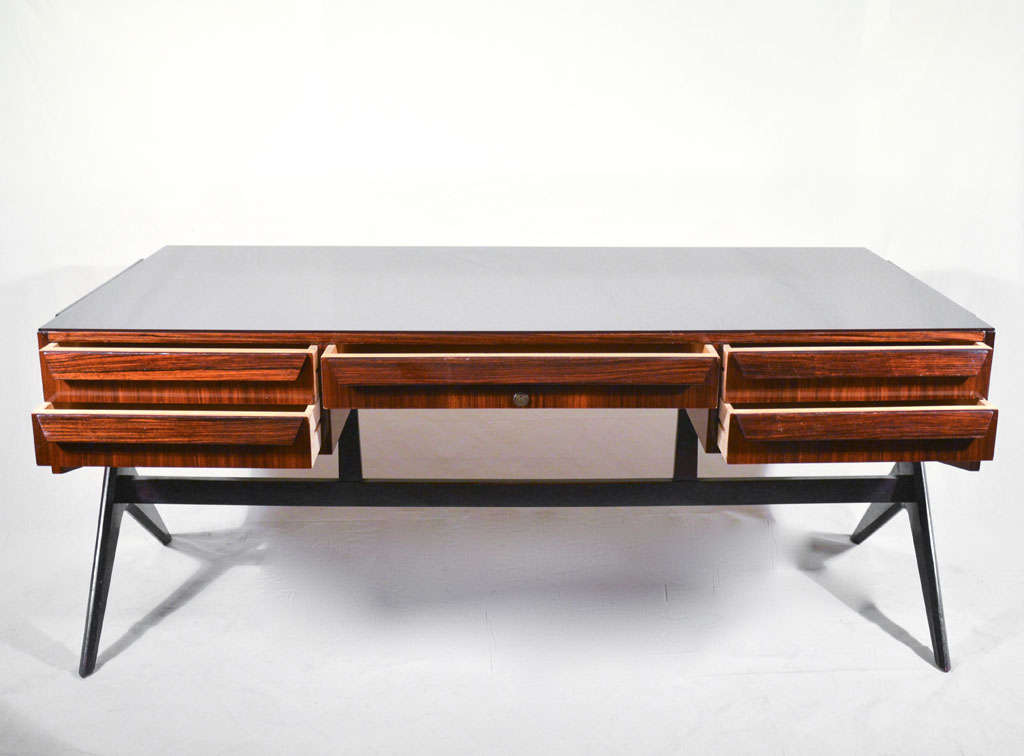important and rare desk by Ico and Luisa Parisi
Italian walnut, glass, circa 1950
	Five drawers but no key available 	
	This desk has numerous details that link the design to Ico and Luisa Parisi. Period 	documentation of Parisi designs