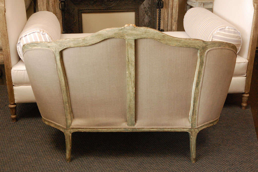 French carved louis 15th sofa upholstered in belgian linen .